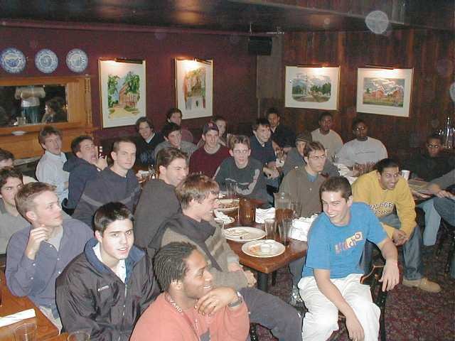A gathering of friends seated around tables indoors